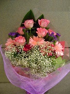 Roses, gerbera, statice, baby's breath, and aspedestra