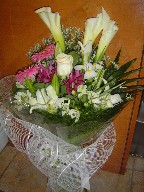 Calla lillies, rose, gerbera, lillies, alstroemeria, limonium, and iris