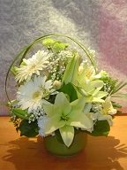 Gerbera, asiatic lilies, baby's breath, alstroemeria, pompoms, monkey grass, and greens