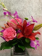 Roses, dendrobium orchids, asiatic lily, pompoms, and monkey grass