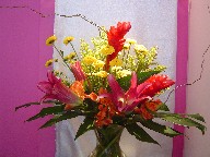 Ginger, lillies, pompoms, solidago, alstroemeria, monstera, and curly willow
