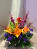 Roses, asiatic lillies, statice, heather, and variegated pitt