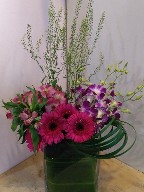 Gerberas, alstoemeria, dendrobium orchids, thlaspia, and monkey grass