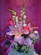 Lillies, roses, snapdragon, baby's breath, daisies, and statice