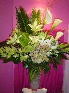 Calla lillies, sago, curly willow, anthurium, lillies, cymbidium and dendrobium orchids, hydreangea, alstroemeria, and monstera