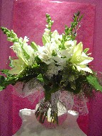 Snapdragon, alstroemeria, lillies, roses, carnations, and philodendron