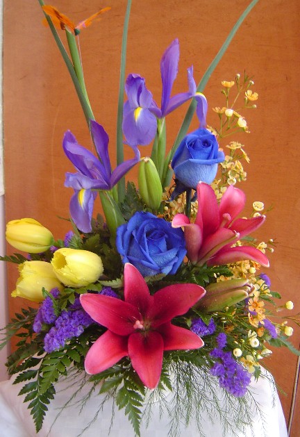 Tulips, iris, roses, lilies, waxflowers, and statice
