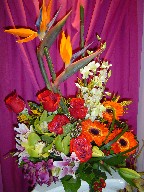 Bird of paradise, roses, gerbera, alstroemeria, lillies, coffee beans, monkey grass, and cymbidium and dendrobium orchids