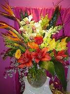Calla lillies, cymbidium orchids, bird of paradise, snapdragon, sago palm, eucalyptus, gerbera, aspedestra, roses, lillies, and curly willow