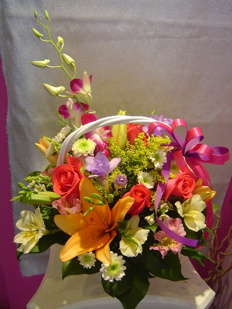 Roses, lilies, dendrobium orchids, daisies, fresia, alstroemeria, solidago, and waxflowers