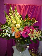 Snapdragon, gerbera, monstera, shocking lillies, roses, coffee beans, dendrobium orchids, and floral cabbage
