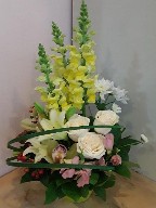 Snapdragon, roses, pompoms, alstroemeria, berries, and orchids