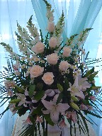 Snapdragon, roses, pompoms, alstroemeria, lillies, and palm leaves