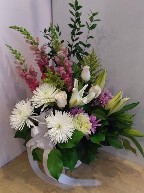 Roses, spider mums, cremons, snapdragon, flat mums, lillies, solidago, and greens