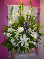 Iris, roses, lillies, snapdragon, dendrobium orchids, solidago, and waxflowers
