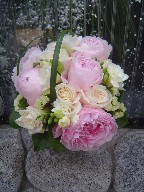 Peonies, roses, fresia, statice, and monkey grass